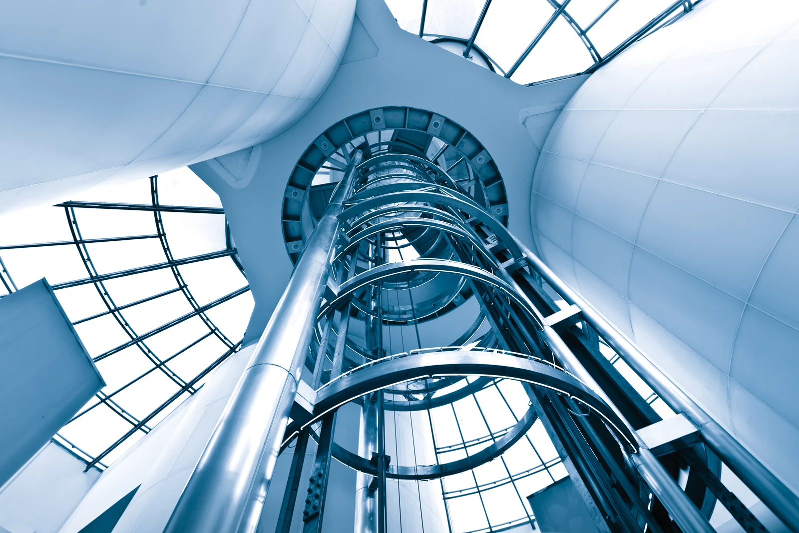 Glass lift shaft in a modern building, looking up
