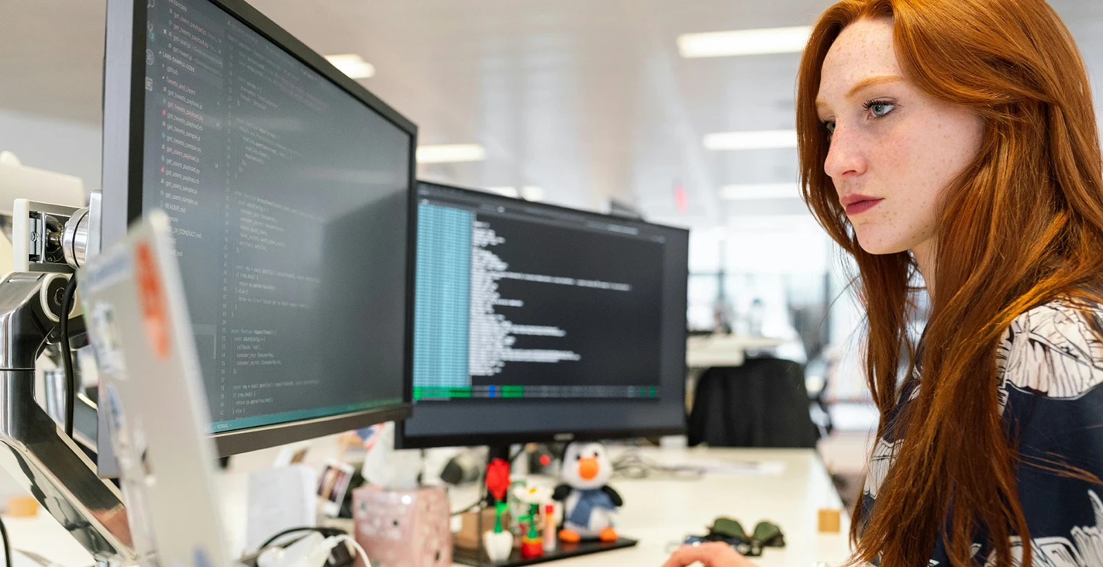 Developer working at screens of code